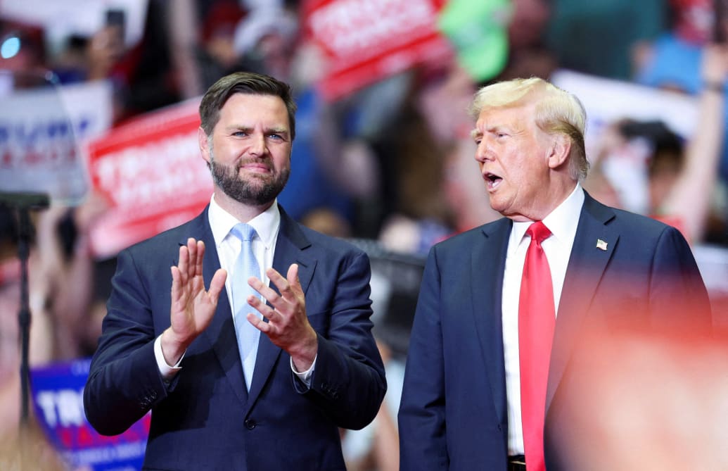 Republican presidential nominee and former U.S. President Donald Trump stands with Republican vice presidential nominee U.S. Senator J.D. Vance, Grand Rapids, Michigan, U.S. July 20, 2024.