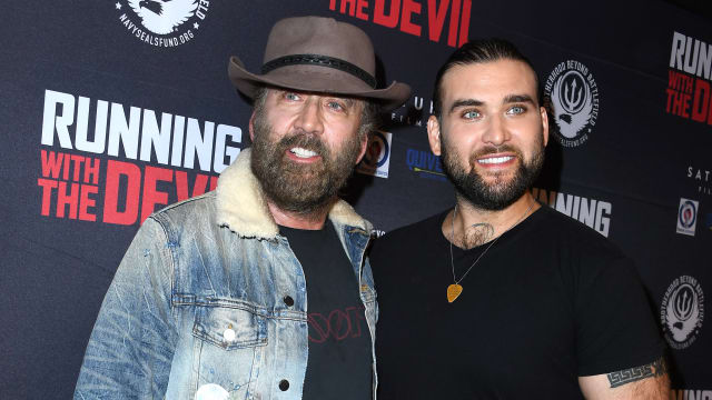 Nicolas Cage and Weston Cage Coppola at a movie premiere. 
