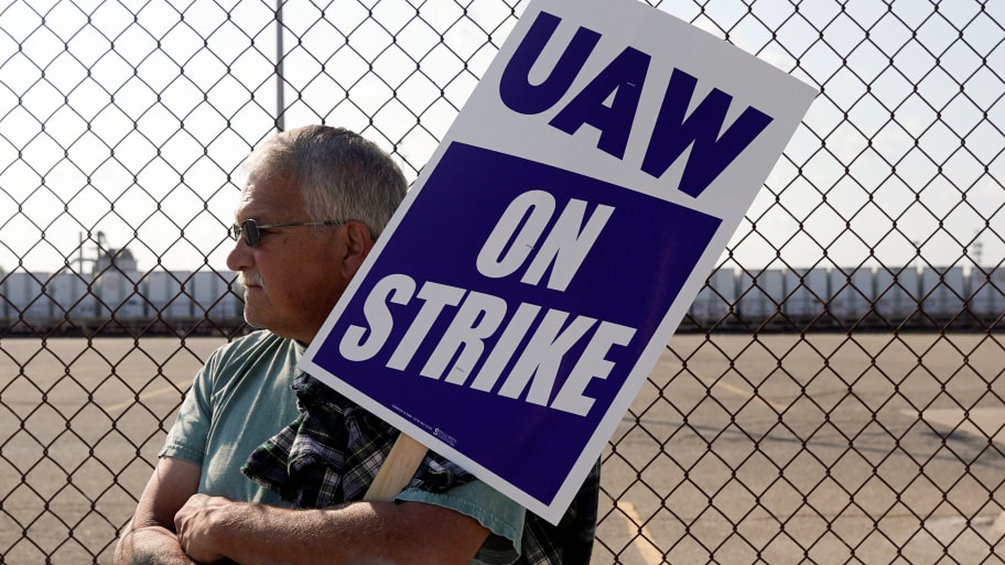A striking UAW member pickets outside a Stellantis facility in Center Line, Michigan