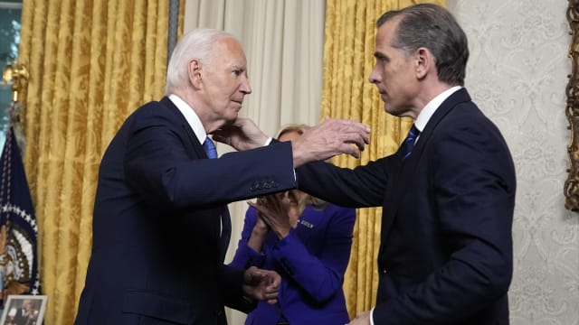 US President Joe Biden hugs his son Hunter Biden (R) after addressing the nation about his decision to not seek reelection, in the Oval Office at the White House in Washington, DC, on July 24, 2024. 