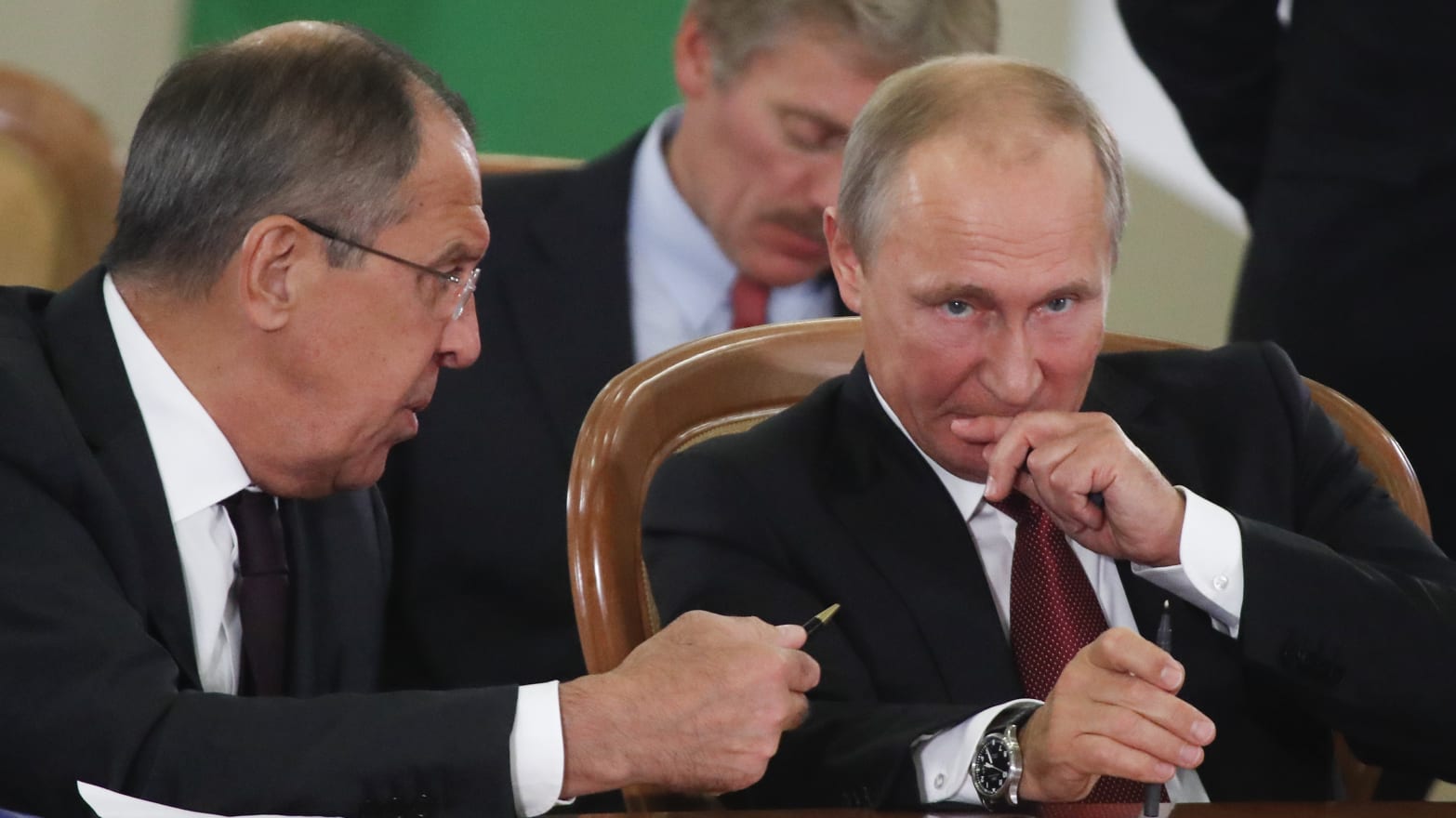 Russia's President Vladimir Putin and Foreign Minister Sergei Lavrov seated at a table.