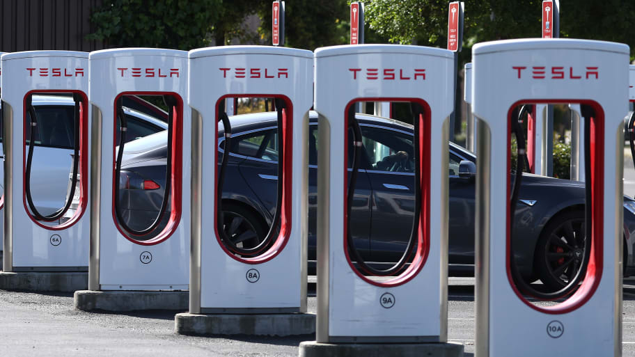 A Tesla car charges up at a Tesla Supercharger on May 2, 2024 in Petaluma, California.