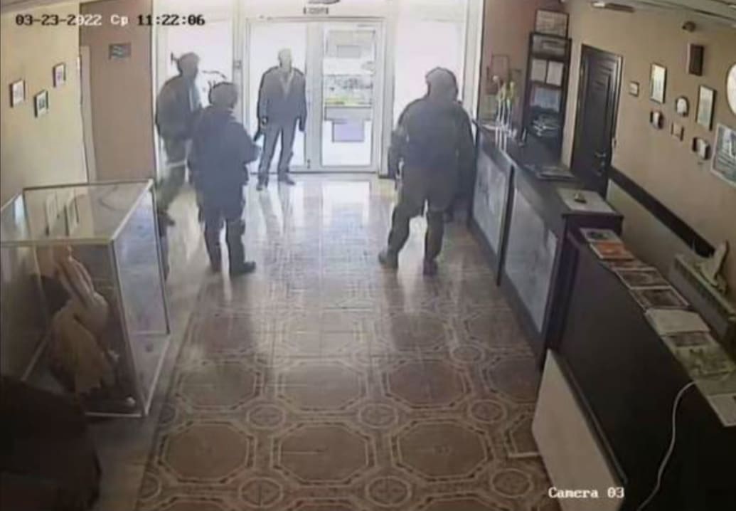 A screenshot of security footage that shows Russian soldiers inside a house