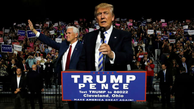 Republican U.S. presidential nominee Donald Trump (R) and vice presidential nominee Mike Pence (L) hold a campaign rally in Cleveland, Ohio, U.S. October 22, 2016. 