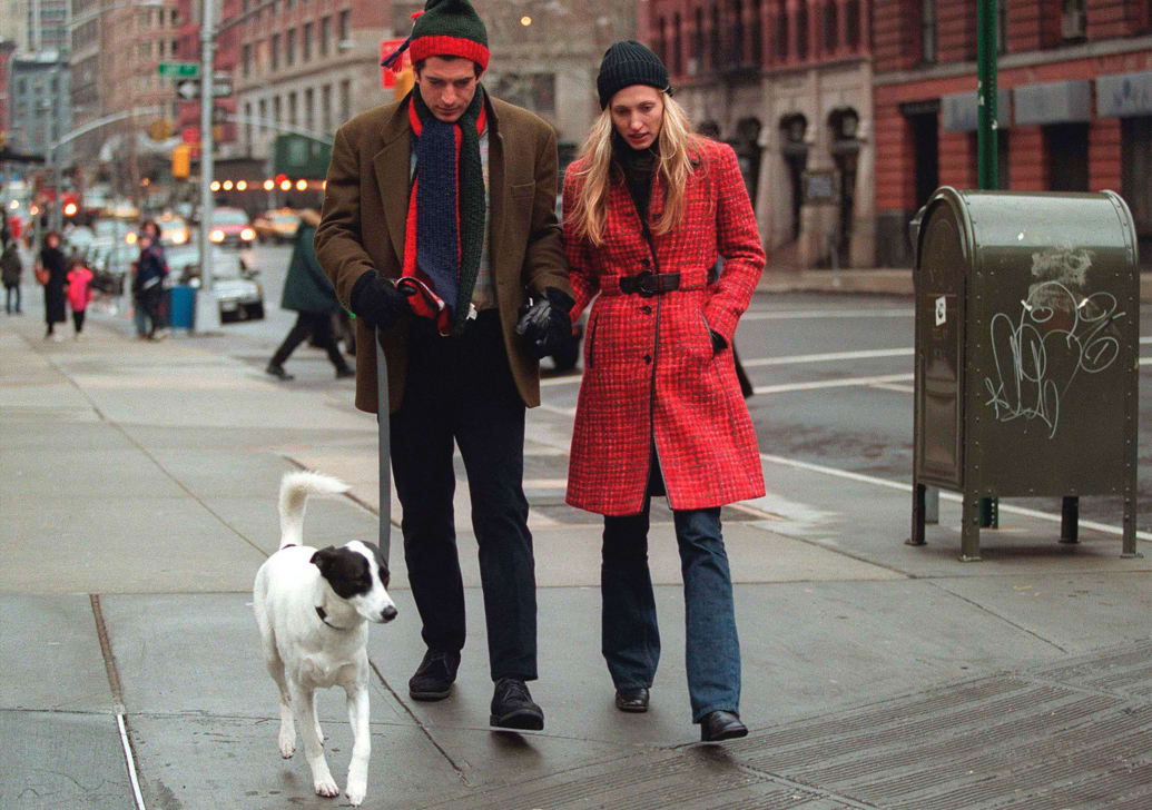 John F. Kennedy Jr. and his wife Carolyn Bessette-Kennedy walk with their dog on January 1, 1997 in New York City. 