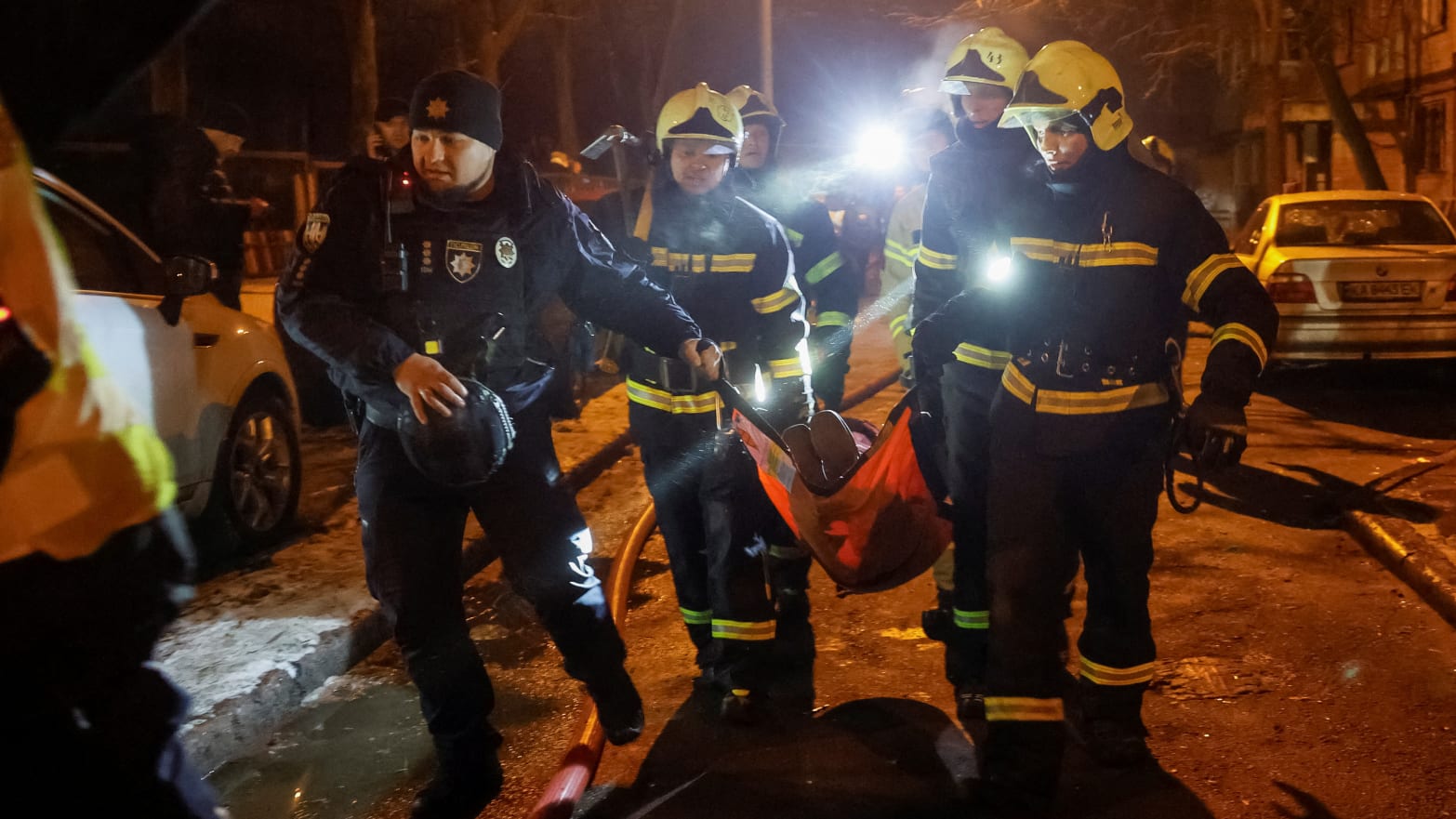 Emergency staff carry a wounded local resident at a site of an apartment building damaged during a Russian missile strike, amid Russia’s attack on Ukraine, in Kyiv, Ukraine December 13, 2023.