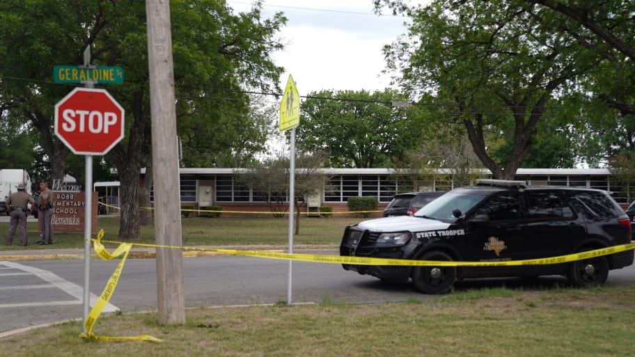 Sheriff crime scene tape is seen outside of Robb Elementary School as State troopers guard the area in Uvalde, Texas