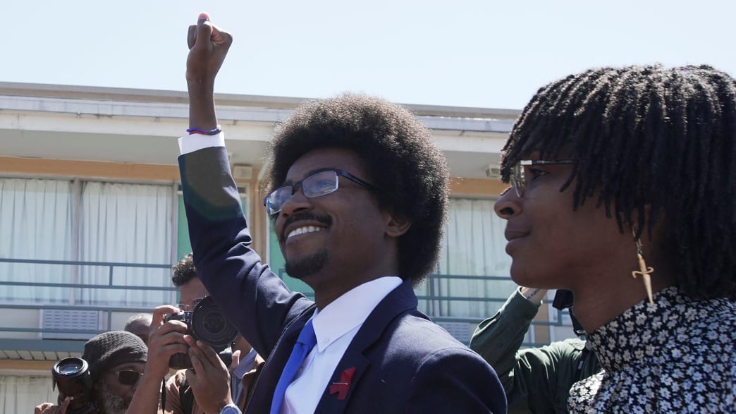 Justin J. Pearson gestures as he marches with supporters from the National Civil Rights Museum to the Shelby County Commission