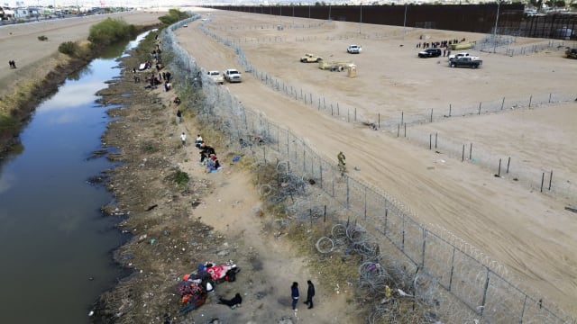 Migrants try to persuade the agents of the Texas National Guard to open the fence in Ciudad Juarez, Mexico on March 19, 2024.