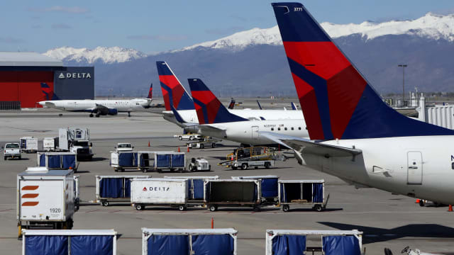 Delta Airlines planes are loaded and unloaded as travel has cutback amid concerns of the coronavirus disease (COVID-19), at Salt Lake City International Airport in Salt Lake City, Utah, U.S. April 14, 2020. 