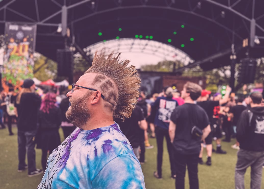 A man with a mohawk with the word “fest” shaved into his head at The Fest in Gainesville