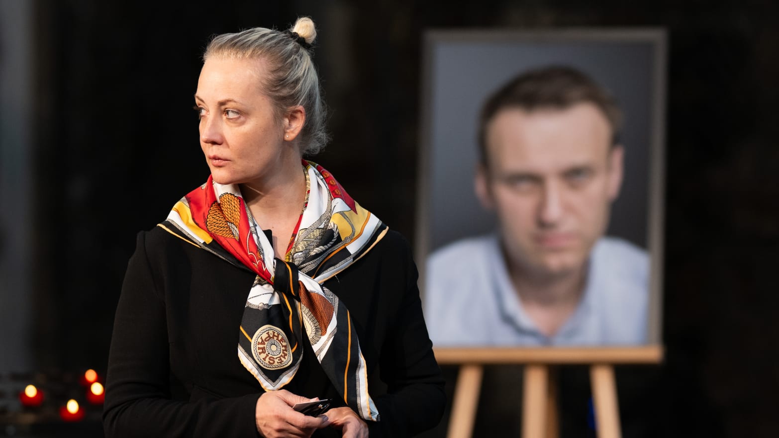 Yulia Navalnaya, widow of Alexei Navalny, walks away from his picture after lighting a candle at the end of a service in St. Mary's Church