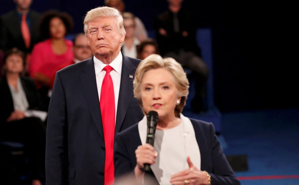 Donald Trump looming behind Hillary Clinton