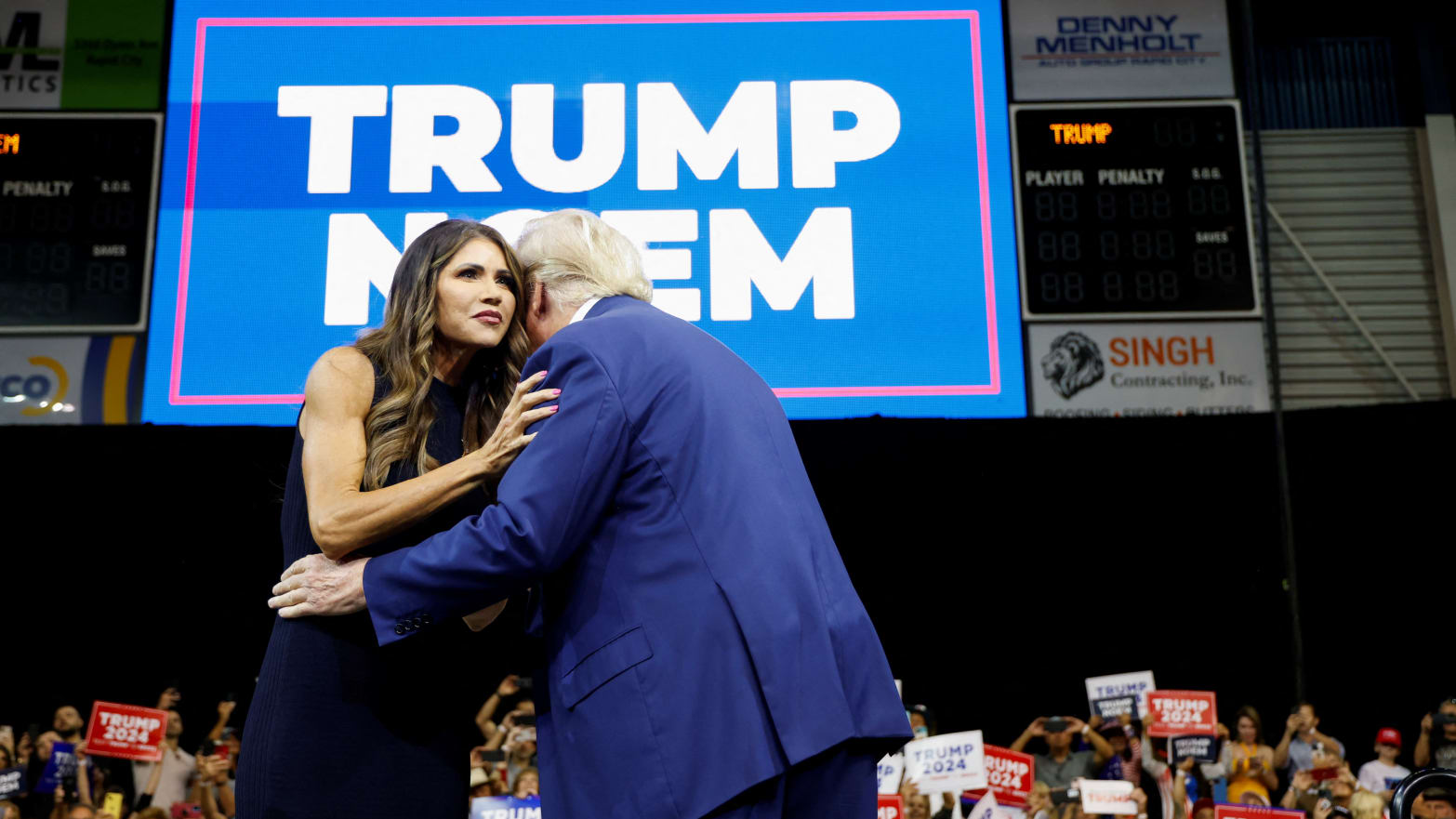 Donald Trump hugs Kristi Noem as he takes the stage in 2023. 