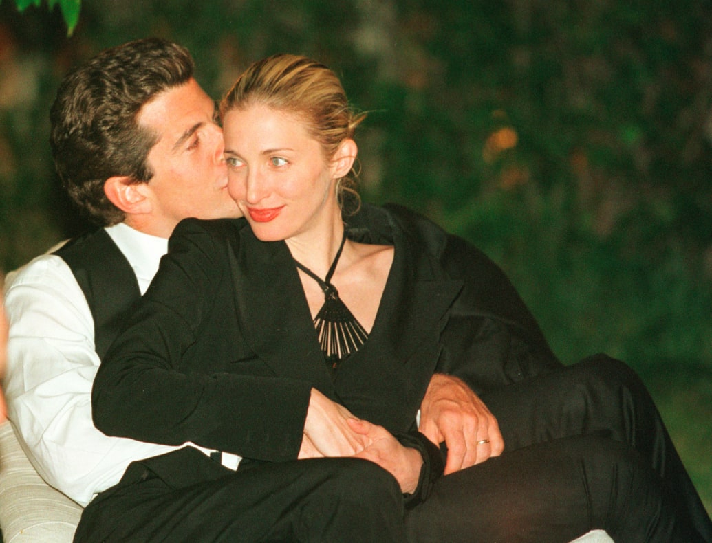 John F. Kennedy, Jr. kisses his wife Carolyn Bessette-Kennedy on the cheek during the White House Correspondents dinner on May 1, 1999 in Washington, D.C.