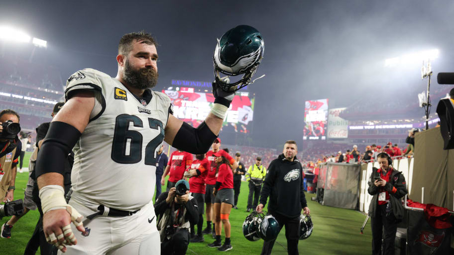 Jason Kelce holds up his helmet to fans as he leaves the field in Tampa.