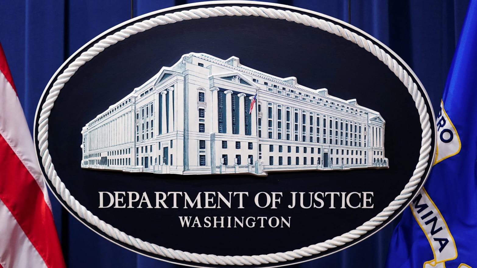 The Department of Justice logo as a backdrop for a press conference.