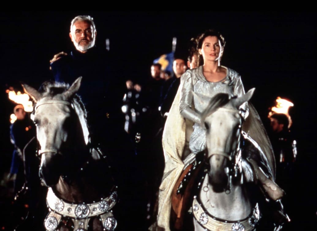 Sean Connery and Julia Ormond on horses in a still from 'First Knight'