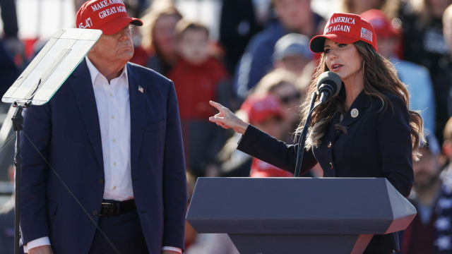 Former US President and Republican presidential candidate Donald Trump listens as North Dakota Governor Kristi Noem speaks during a Buckeye Values PAC Rally in Vandalia, Ohio, on March 16, 2024. 
