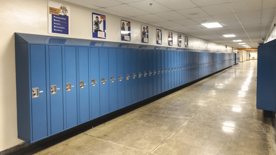 A picture shows an empty corridor and student lockers of a school. An Alabama elementary school investigated one of its own teachers after community members suspected her of taking part in a viral Montgomery riverfront dock brawl.