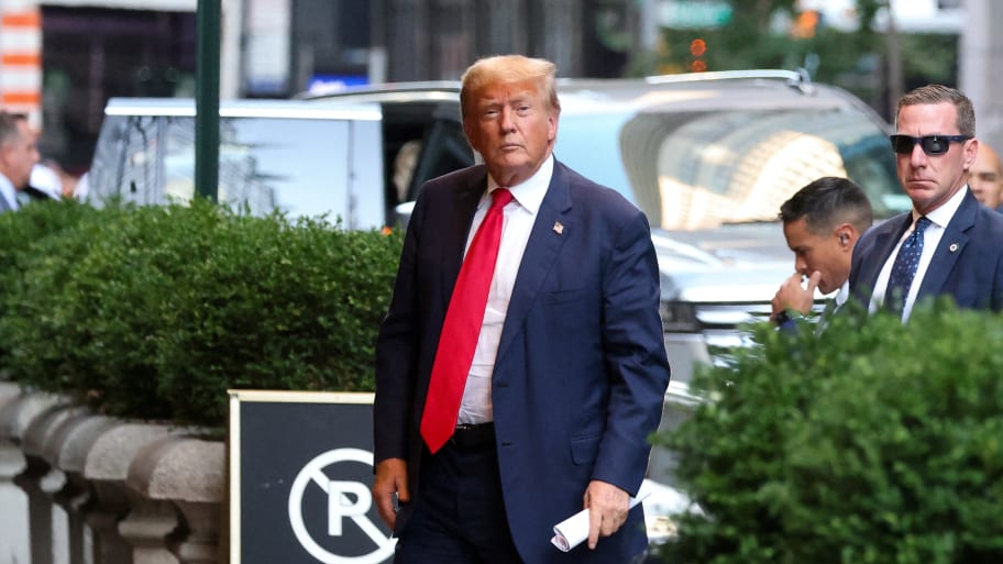 Donald Trump walks outside as the trial of himself, his adult sons, the Trump Organization and others in a civil fraud case