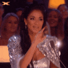 Gif of bedazzled woman blowing a kiss.