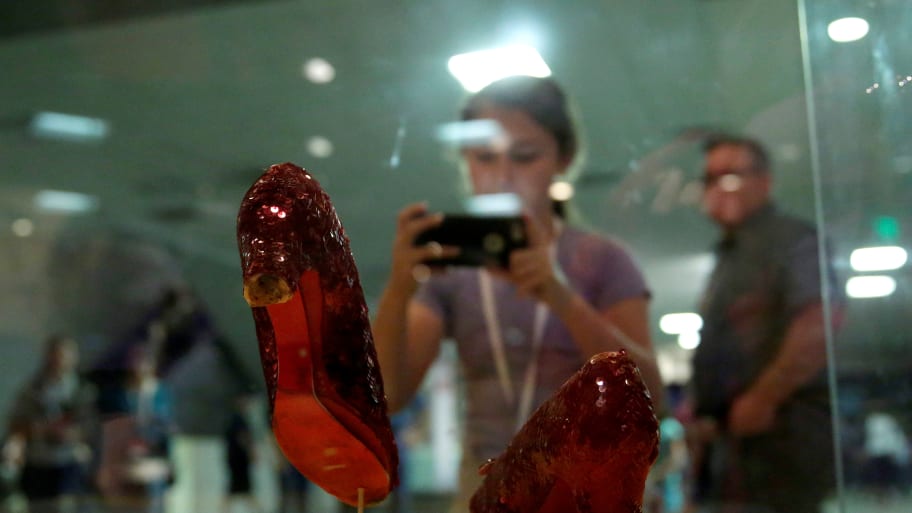 A girl photographs the Ruby Red Slippers worn by Judy Garland in the movie the \"Wizard of Oz\" at the Smithsonian Museum of American History in Washington.