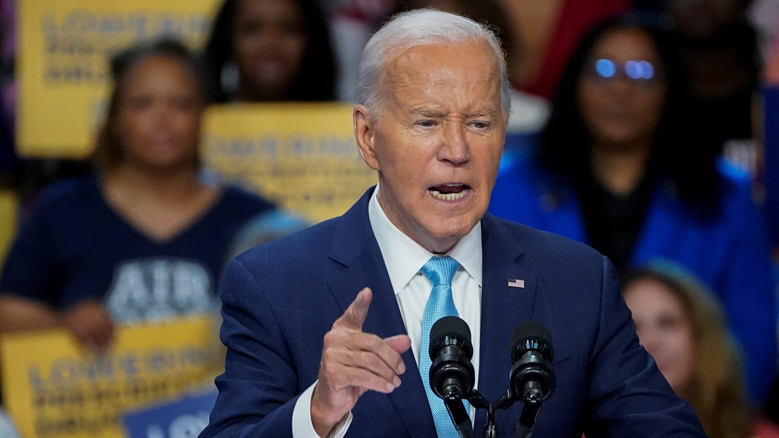 A photo of Joe Biden speaking at a podium.