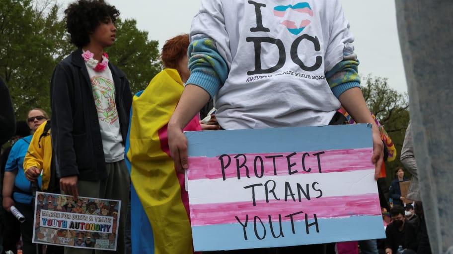 A person holds a sign during a \"March for Queer & Trans Youth Autonomy\" in Washington, D.C.