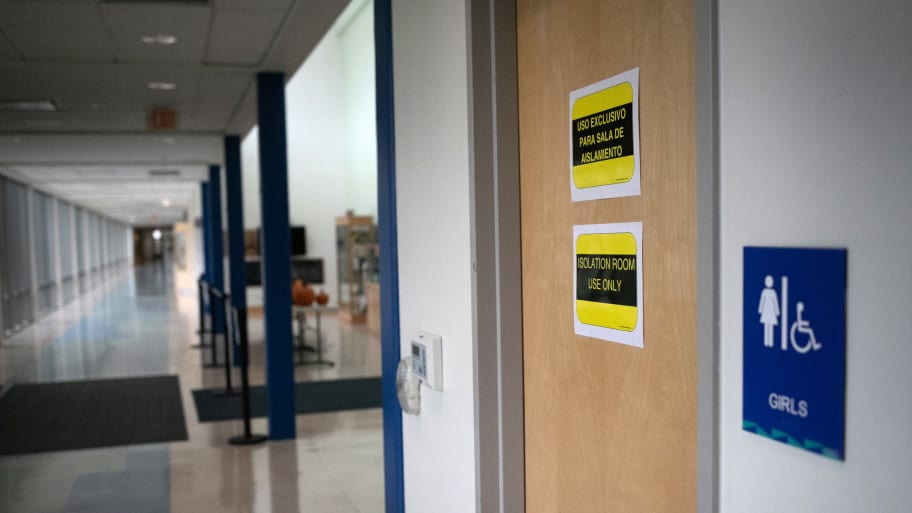 Signs mark a bathroom next to an "isolation room" set up for students or faculty with potential COVID-19 symptoms at Rogers International School on October 21, 2020 in Stamford, Connecticut