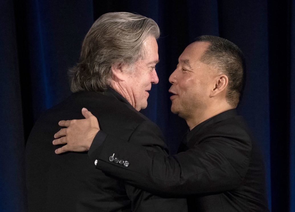 Former White House Chief Strategist Steve Bannon greets fugitive Chinese billionaire Guo Wengui before introducing him at a news conference on November 20, 2018 in New York.