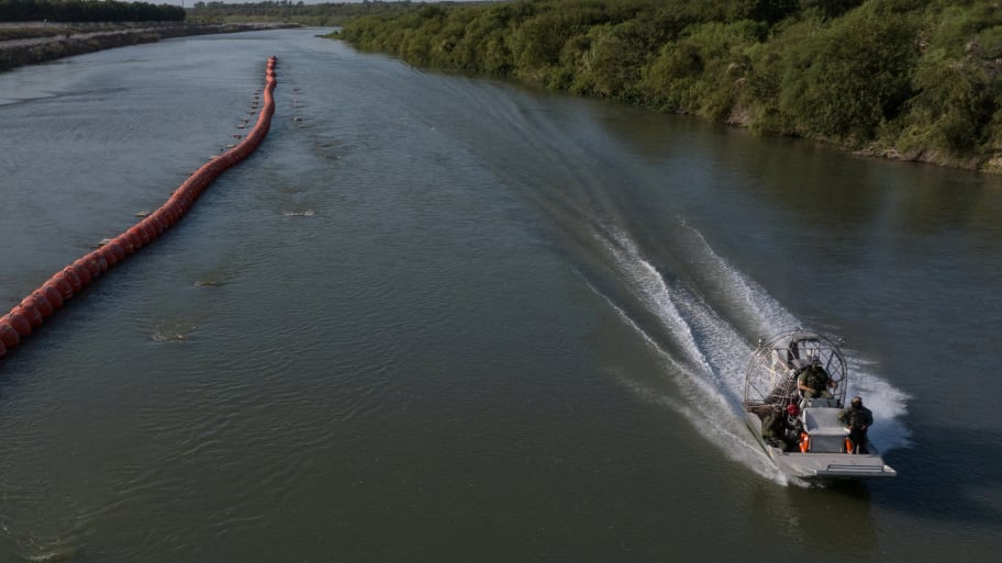 Texas Department of Public Safety (DPS) troopers ride past buoys while patrolling the Rio Grande river along the international boundary of the United States and Mexico near Eagle Pass, Texas, U.S. July 29, 2023. 