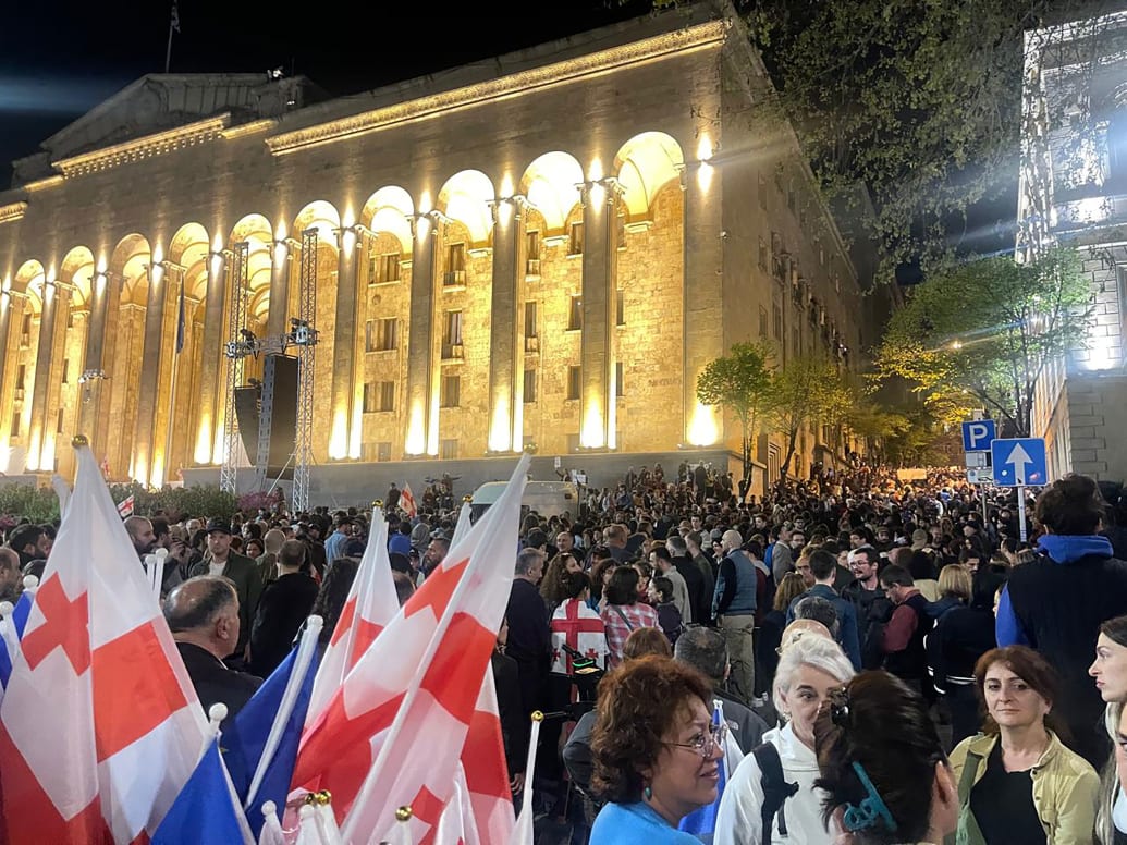 A photo of a crowd of people outside the Georgian Parliament. 