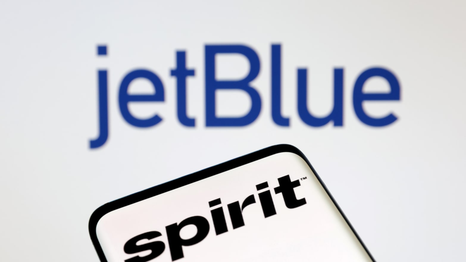 A graphic showing JetBlue and Spirit’s logos.