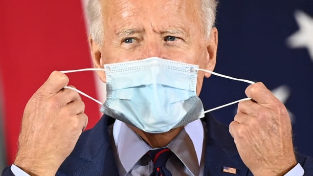 Joe Biden puts on a face mask in October 2020.