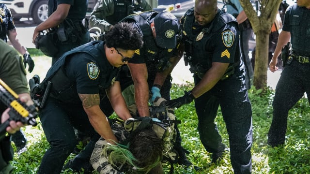 Police officers arrest a demonstrator during a pro-Palestinian protest against the war in Gaza at Emory University on April 25, 2024, in Atlanta, Georgia.