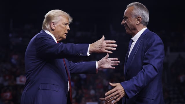 Donald Trump is greeted by Robert F. Kennedy Jr.