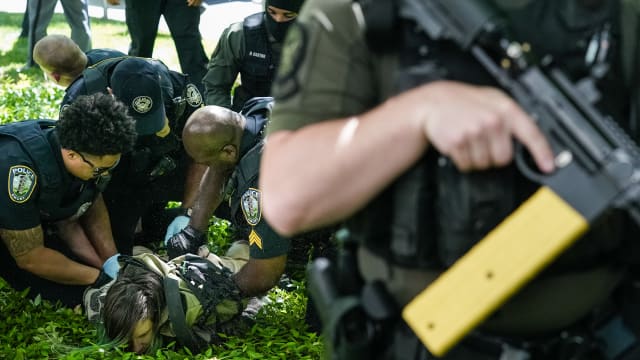 Police officers detain a demonstrator during a pro-Palestinian protest against the war in Gaza at Emory University on April 25, 2024, in Atlanta, Georgia.