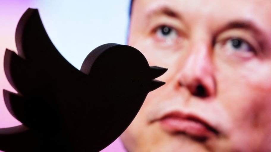 An illustration of a 3D Twitter logo displayed on top of a photo of Elon Musk