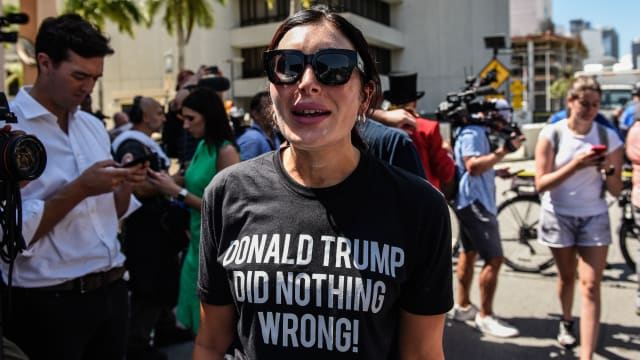 Right wing pundit Laura Loomer stands amid a rally outside a US Federal Courthouse with supporters of former President Donald Trump.