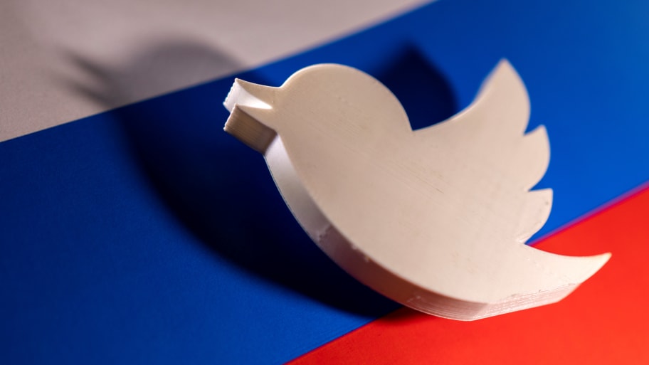 A picture of a Twitter logo placed on a Russian flag. Under Elon Musk, Twitter’s policies allowed Russian propaganda about Ukraine to run wild on the platform and spread to more users than before the war began, according to a study released by the EU.