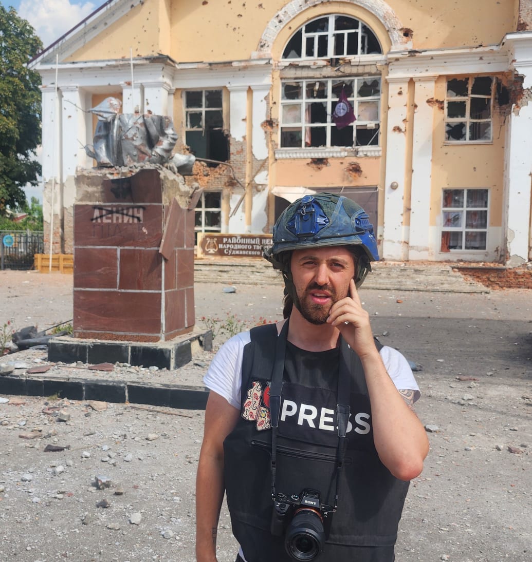 Thomas Mutch in front of the destroyed Lenin Statue in Sudzha, Russia.