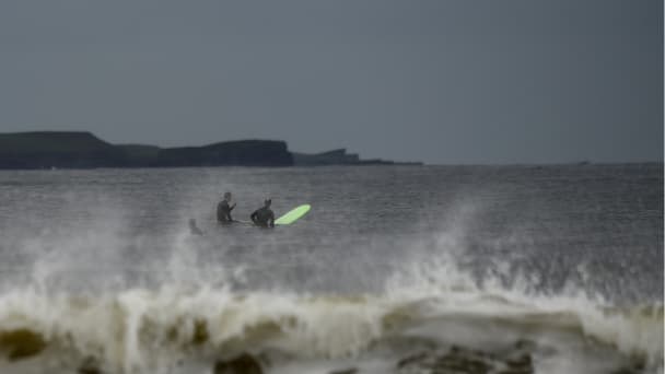 Surfers wait in the Atlantic on their surfboard for big waves to hit on the eve of storm Ophelia in the County Clare town of Lahinch, Ireland October 15, 2017.