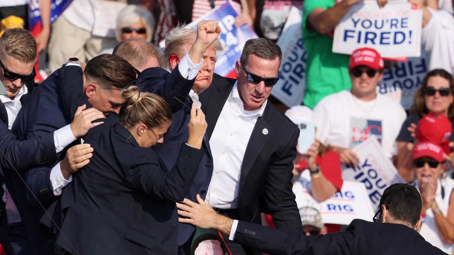 Republican presidential candidate and former U.S. President Donald Trump gestures with a bloodied ear as multiple shots rang out during a campaign rally at the Butler Farm Show in Butler, Pennsylvania, U.S., July 13, 2024. 