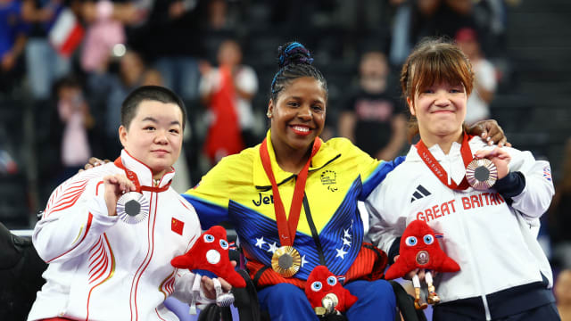 Gold medallist Clara Sarahy Fuentes Monasterio of Venezuela celebrates with her medal on the podium along with silver medallist Jinping Xiao of China and bronze medallist Olivia Broome of Britain