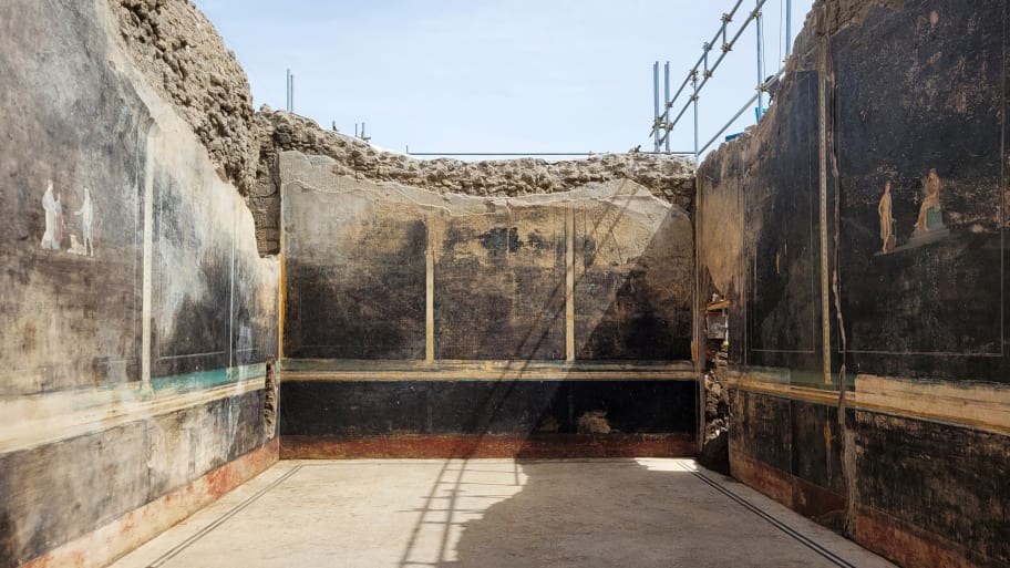 A view of a black-walled dining hall with 2,000-year old paintings inspired by the Trojan War is seen in this handout picture taken in the ancient archeological site of Pompeii.
