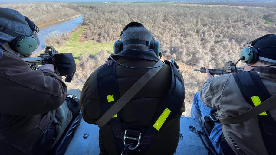 Three hunters aboard a HeliBacon helicopter hunt for feral hogs in Bryan, Texas.