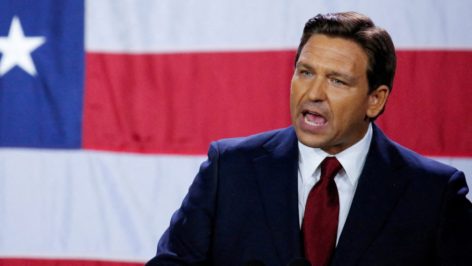 Ron DeSantis speaks passionately in front of a U.S. flag