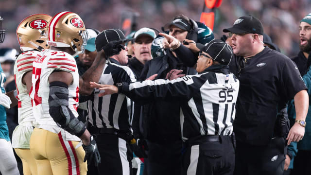 San Francisco 49ers linebacker Dre Greenlaw (57) has an altercation with Philadelphia Eagles staff member Dom DiSandro