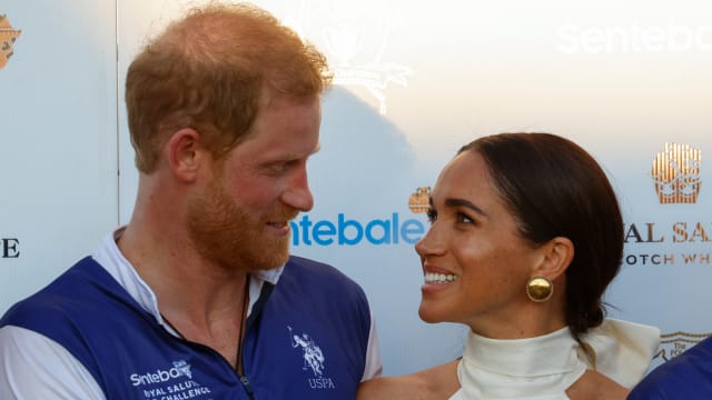 Britain's Prince Harry and Meghan, Duchess of Sussex, look at each other as they attend the Royal Salute Polo Challenge to benefit Sentebale, in Wellington, Florida, U.S., April 12, 2024.